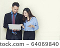 Two business people working and talking about job 64069840