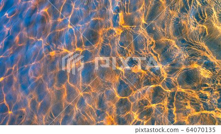 Glare of the sun and waves at the bottom of the river Glare of the sun and waves at the bottom of the river 64070135