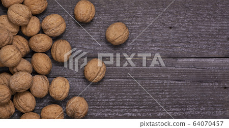 scattering of walnuts on a wooden background 64070457