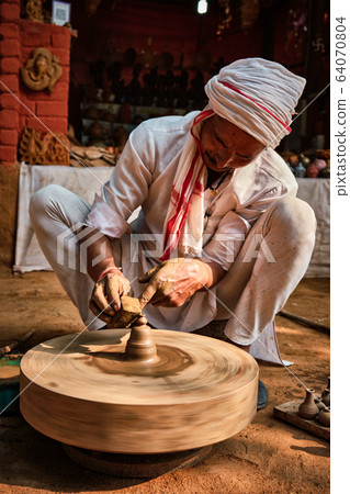 Indian potter at work, Shilpagram, Udaipur, Rajasthan, India Indian potter at work, Shilpagram, Udaipur, Rajasthan, India 64070804