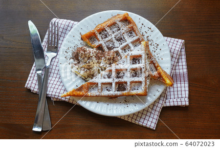 wafers covered with cream and chocolate on a plate. 64072023