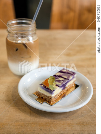 Purple taro cream cake with biscuit and ice coffee Purple taro cream cake with biscuit and ice coffee 64072592
