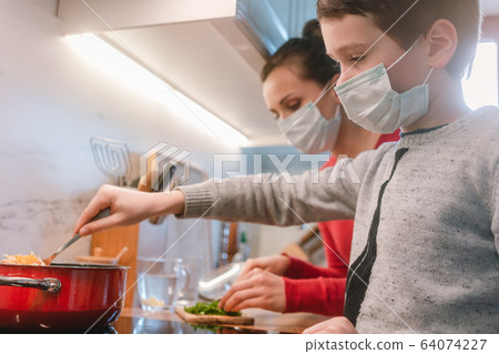 Mother and son cooking at home during the crisis time Mother and son cooking at home during the crisis time 64074227