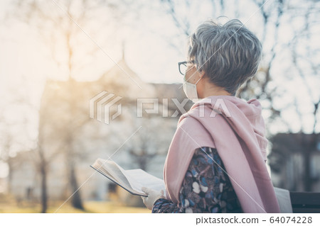 Senior woman praying for end of coronavirus crisis Senior woman praying for end of coronavirus crisis 64074228