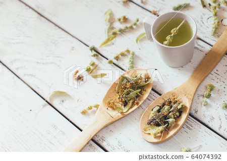 Natural organic herbal green tea in wooden spoons. Natural organic herbal green tea in wooden spoons. 64074392