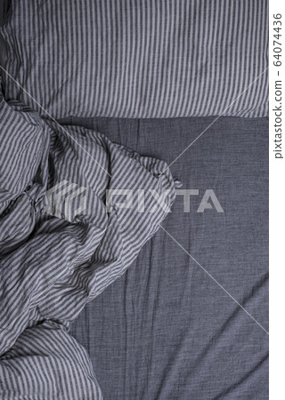 Bed with pillows and a blanket 64074436