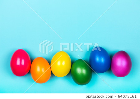 Different colorful eggs in neon trendy colors on blue pastel background. Different colorful eggs in neon trendy colors on blue pastel background. 64075161