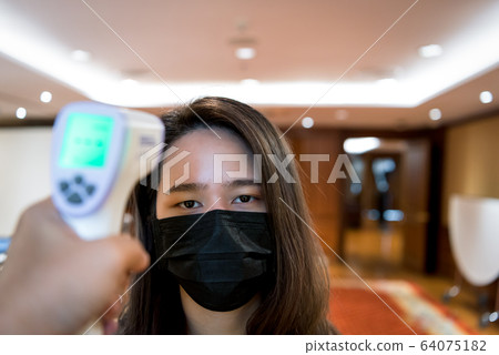 Woman wearing mask protection flu with thermoscan Woman wearing mask protection flu with thermoscan 64075182