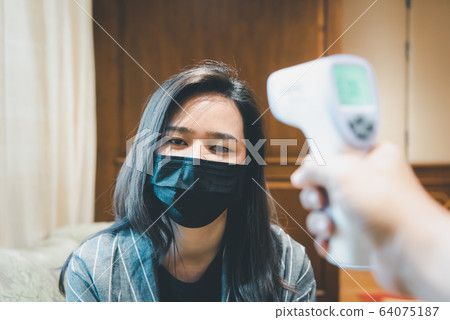 Woman wearing mask protection flu with thermoscan Woman wearing mask protection flu with thermoscan 64075187