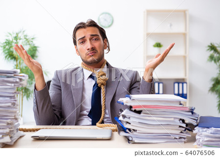 Young male employee unhappy with excessive work Young male employee unhappy with excessive work 64076506