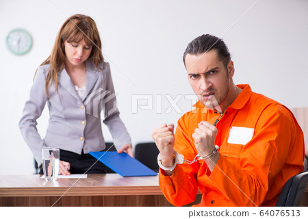 Young man meeting with advocate in pre-trial detention Young man meeting with advocate in pre-trial detention 64076513
