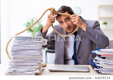 Young male employee unhappy with excessive work Young male employee unhappy with excessive work 64076514