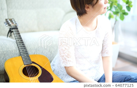 Woman with acoustic guitar Woman with acoustic guitar 64077125