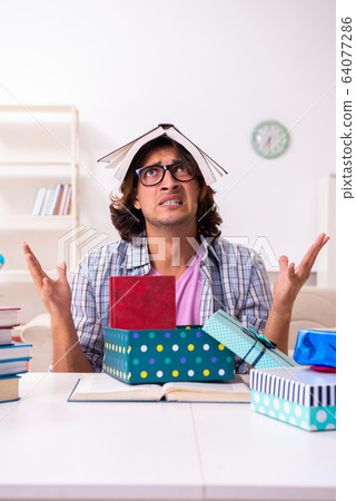 Young male student preparing for exams during Christmas 64077286