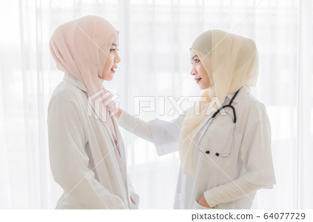 Female muslim doctor talk to patient. 64077729