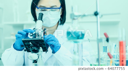 Scientis using microscope to work in lab. Scientis using microscope to work in lab. 64077755