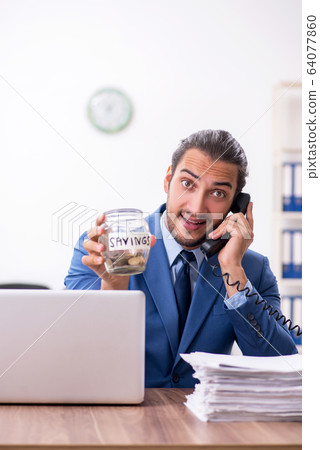 Young male businessman working in the office Young male businessman working in the office 64077860