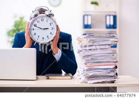 Young male employee unhappy with excessive work Young male employee unhappy with excessive work 64077974