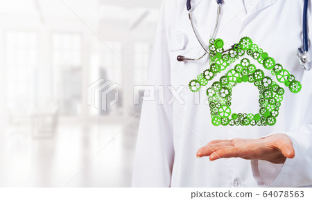 Symbol of homepage or accomodation made with cogwheels presented in female palms 64078563