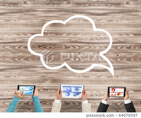 Top view of businesspeople sitting at table and using gadgets 64078597