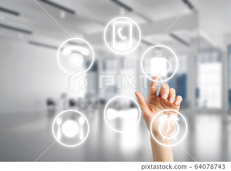 Modern office interior and close of businesswoman hand choosing symbol on application interface 64078743