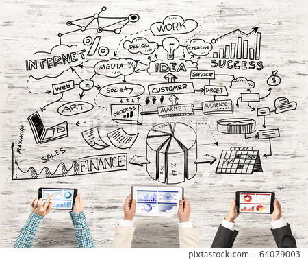 Top view of businesspeople sitting at table and using gadgets Top view of businesspeople sitting at table and using gadgets 64079003