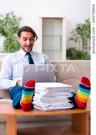 Young male businessman working at home Young male businessman working at home 64079069