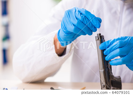 Male expert criminologist working in the lab for evidence 64079101