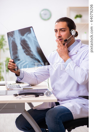Young doctor listening to patient during telemedicine session Young doctor listening to patient during telemedicine session 64079206