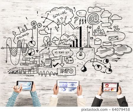 Top view of businesspeople sitting at table and using gadgets Top view of businesspeople sitting at table and using gadgets 64079458
