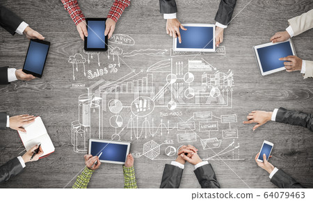 Top view of businesspeople sitting at table and using gadgets Top view of businesspeople sitting at table and using gadgets 64079463