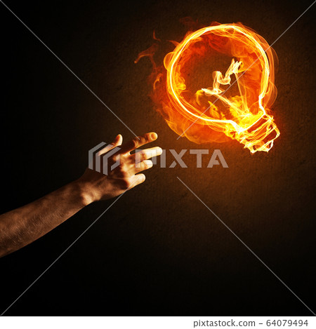 Concept of electricity or inspiration with burning light bulb and creation gesture Concept of electricity or inspiration with burning light bulb and creation gesture 64079494