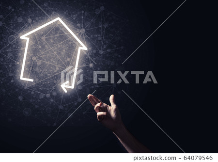Conceptual image with hand pointing at house or main page icon o 64079546