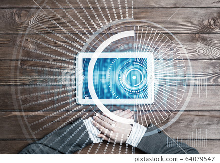 Business workplace with tablet device on wooden surface and media interface Business workplace with tablet device on wooden surface and media interface 64079547