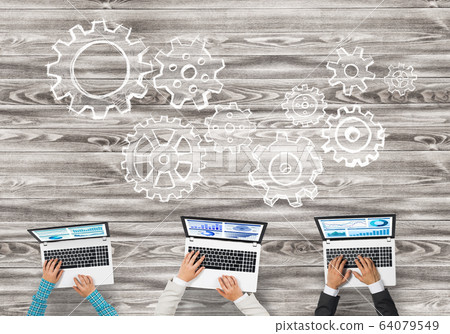 Top view of businesspeople sitting at table and using gadgets Top view of businesspeople sitting at table and using gadgets 64079549