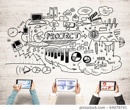 Top view of businesspeople sitting at table and using gadgets Top view of businesspeople sitting at table and using gadgets 64079791