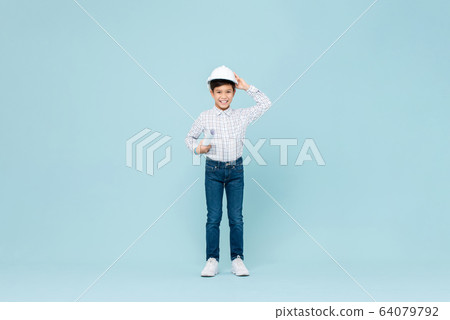 Smiling Asian boy wearing engineer hardhat and blueprint Smiling Asian boy wearing engineer hardhat and blueprint 64079792