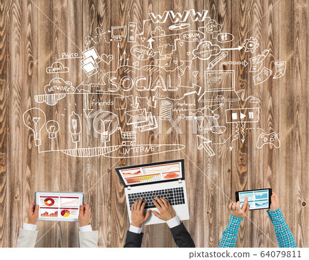 Top view of businesspeople sitting at table and using gadgets Top view of businesspeople sitting at table and using gadgets 64079811