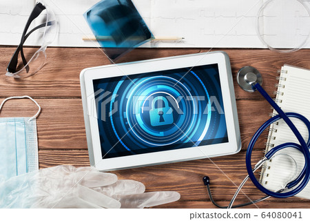 Web security and technology concept with tablet pc on wooden table Web security and technology concept with tablet pc on wooden table 64080041
