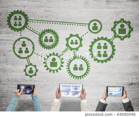 Top view of businesspeople sitting at table and using gadgets 64080046