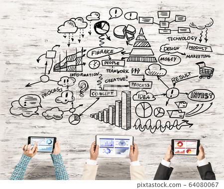 Top view of businesspeople sitting at table and using gadgets Top view of businesspeople sitting at table and using gadgets 64080067