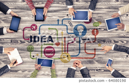 Top view of businesspeople sitting at table and using gadgets 64080198