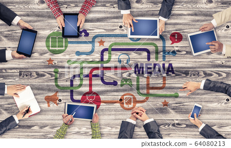 Top view of businesspeople sitting at table and using gadgets Top view of businesspeople sitting at table and using gadgets 64080213