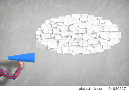 Hand of woman holding blue paper trumpet against concrete background Hand of woman holding blue paper trumpet against concrete background 64080217