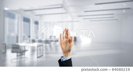 Choosing gesture of businessperson in elegant modern interior in sunshine light Choosing gesture of businessperson in elegant modern interior in sunshine light 64080219