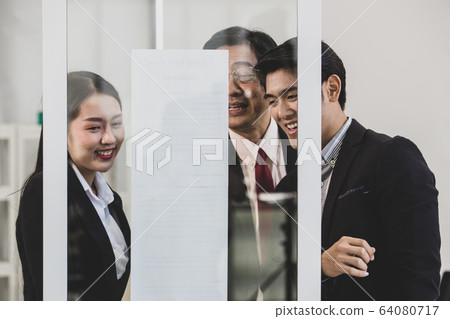 Businesspeople surrounded the placard board. Businesspeople surrounded the placard board. 64080717
