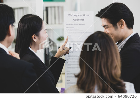 Businesspeople surrounded the placard board. Businesspeople surrounded the placard board. 64080720