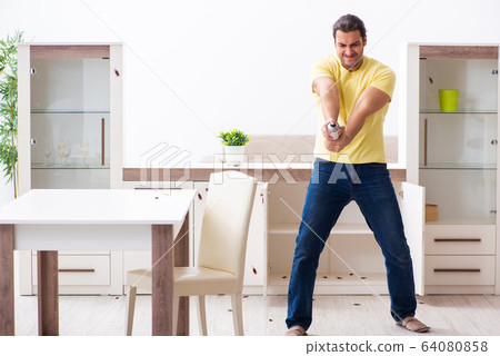 Young man and a lot of cockroaches at home 64080858