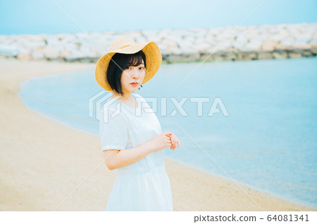 Young woman walking on the seaside Young woman walking on the seaside 64081341
