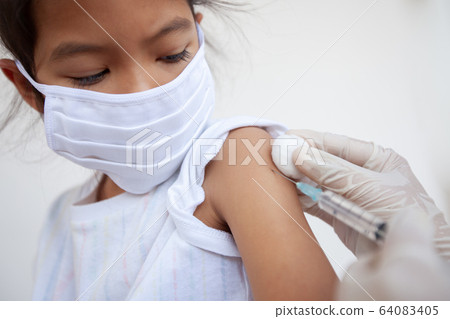 Doctor injecting vaccination on asian child girl arm 64083405